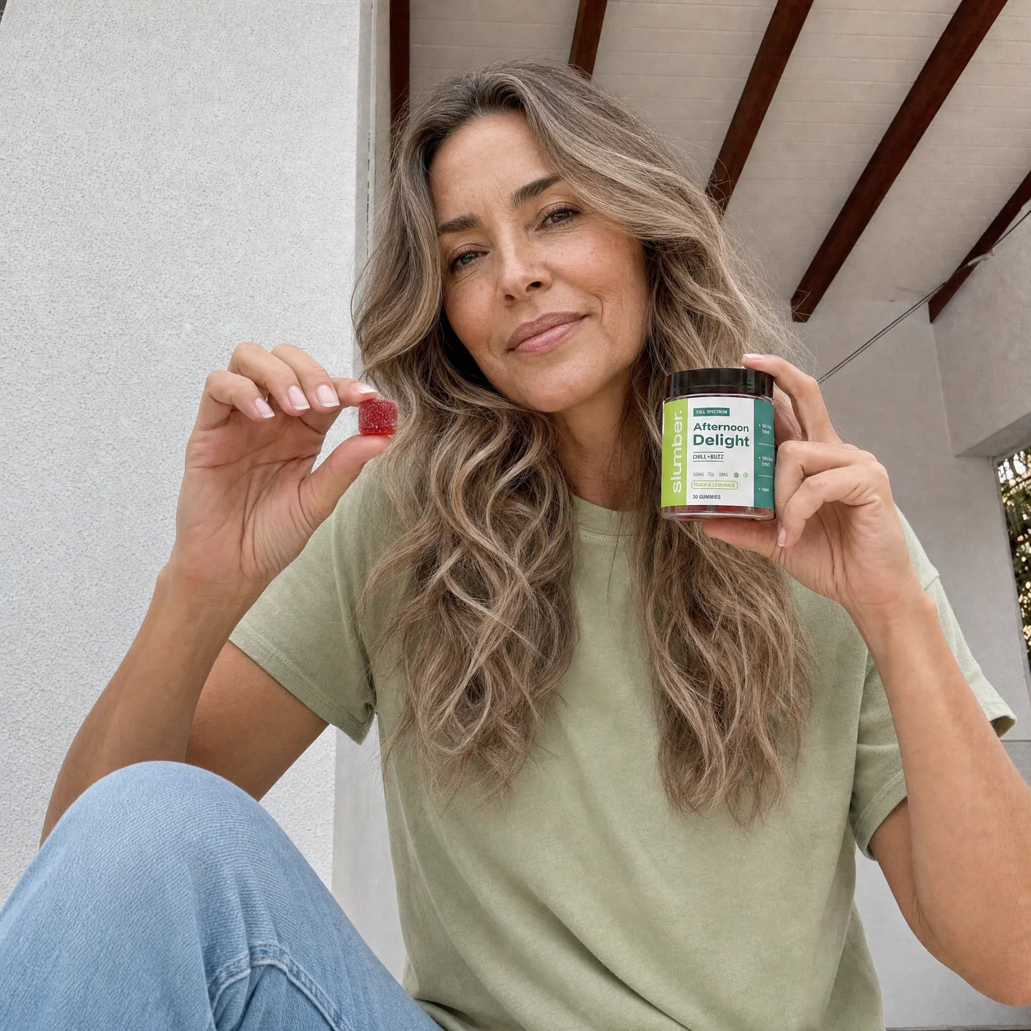 Woman smiling with a gummy in hand